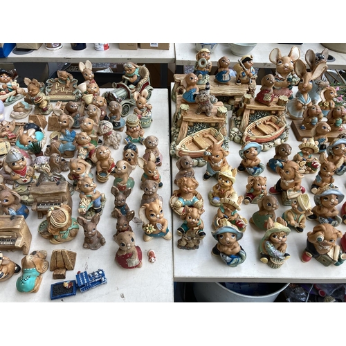 431 - An extensive collection of Pendelfin rabbit figurines and display stands to include Betsy Barge, Fat... 