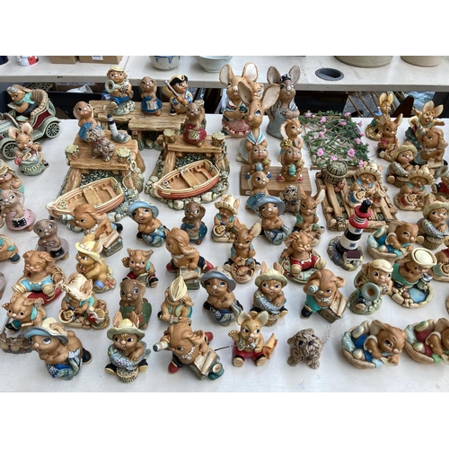 431 - An extensive collection of Pendelfin rabbit figurines and display stands to include Betsy Barge, Fat... 