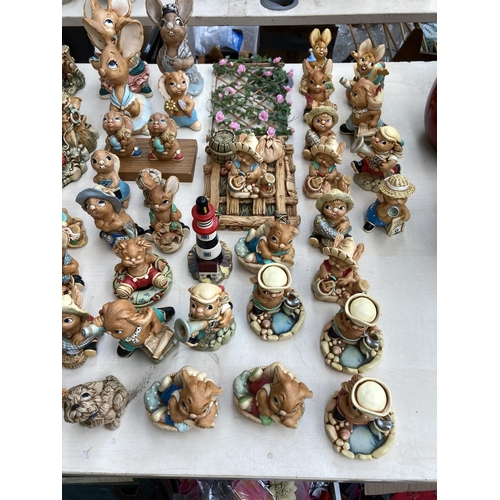 431 - An extensive collection of Pendelfin rabbit figurines and display stands to include Betsy Barge, Fat... 