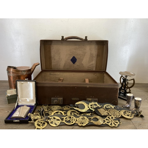 446 - An early 20th century brown leather suitcase containing a collection of antique and later metalware ... 