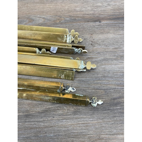 449 - Twelve late 19th century brass stair rods - each approx. 75cm long