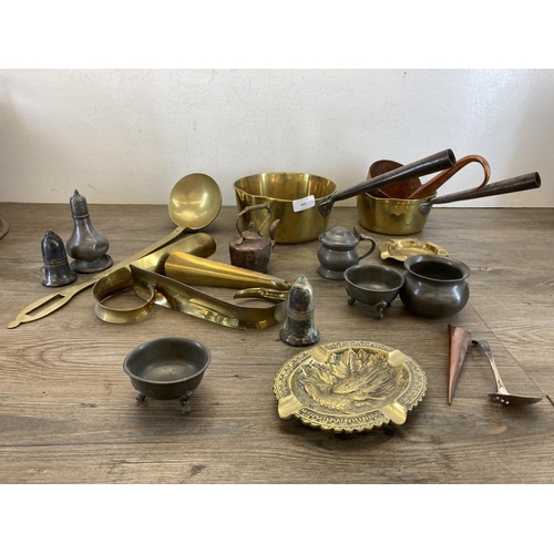 451 - A collection of antique and later metalware to include two 19th century brass graduating saucepans, ... 