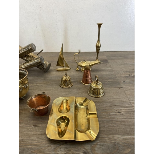 453 - A collection of vintage brass and copperware to include brass bullet desk ornament, brass log splitt... 