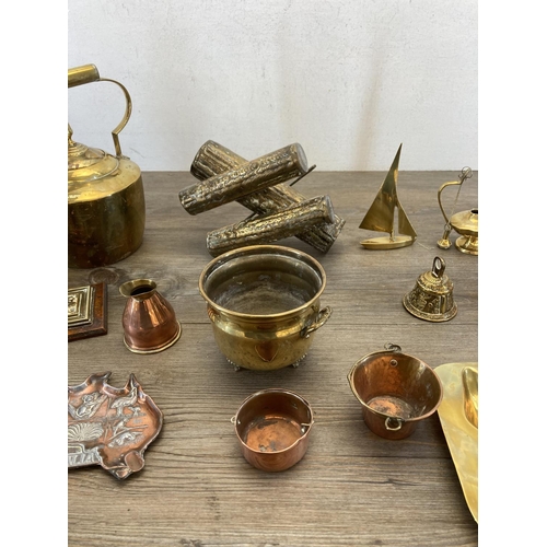 453 - A collection of vintage brass and copperware to include brass bullet desk ornament, brass log splitt... 