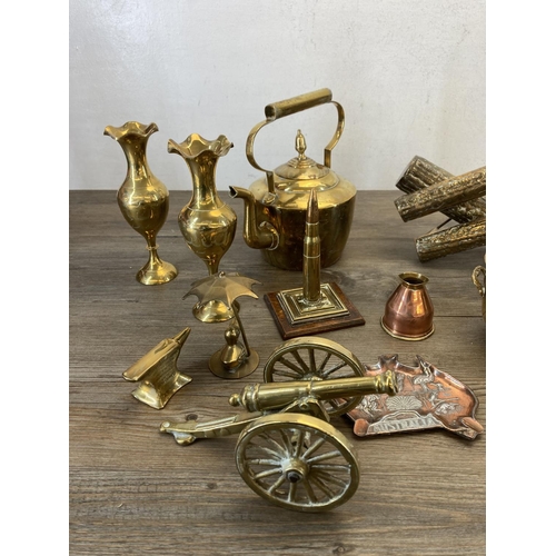 453 - A collection of vintage brass and copperware to include brass bullet desk ornament, brass log splitt... 