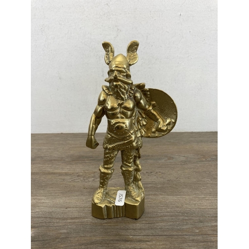 464 - Four pieces of brassware, cast dog figurine, Viking figurine, squirrel ornament and chamberstick