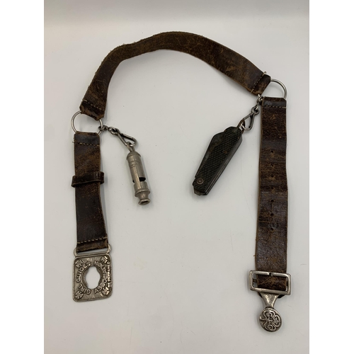 2310 - A vintage Girl Guides Association leather belt with attached The Acme City Whistle and Taylor Sheffi... 