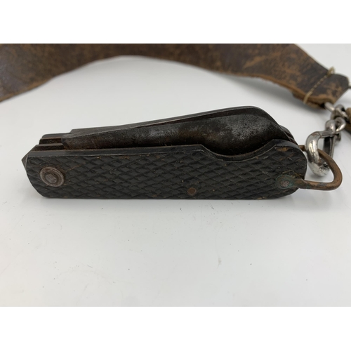 2310 - A vintage Girl Guides Association leather belt with attached The Acme City Whistle and Taylor Sheffi... 