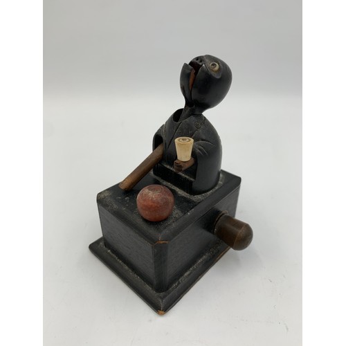 2313 - An early 20th century Japanese Kobe carved and ebonised wooden automaton toy - approx. 9cm high