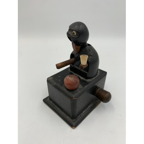 2313 - An early 20th century Japanese Kobe carved and ebonised wooden automaton toy - approx. 9cm high