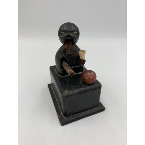 2313 - An early 20th century Japanese Kobe carved and ebonised wooden automaton toy - approx. 9cm high