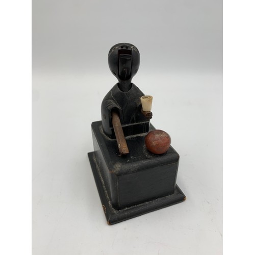 2313 - An early 20th century Japanese Kobe carved and ebonised wooden automaton toy - approx. 9cm high