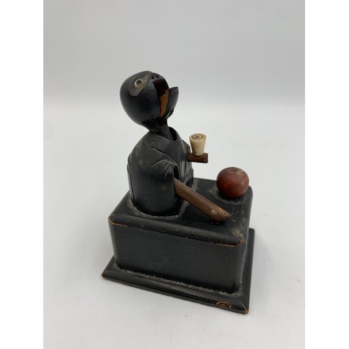 2313 - An early 20th century Japanese Kobe carved and ebonised wooden automaton toy - approx. 9cm high