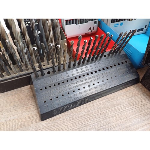 1064 - Two boxes, one containing a large quantity of cased mostly Dormer drill bit sets and one containing ... 
