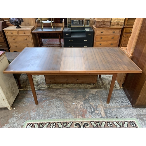 109 - A mid 20th century A.H. McIntosh & Co Ltd teak and walnut extending dining table - approx. 76cm high... 