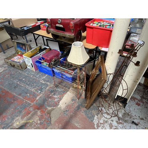 1107 - Four boxes containing Manchester United magazines, metal violin shaped candle holder, gilt framed be... 