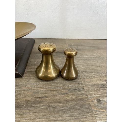 519 - A set of 19th century brass balance scales on stained mahogany base - approx. 59cm high x 53cm wide ... 