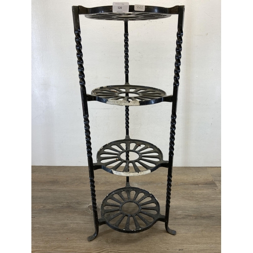 520 - Two wrought iron items, one black painted four tier kitchen pan stand - approx. 77cm high and one 19... 