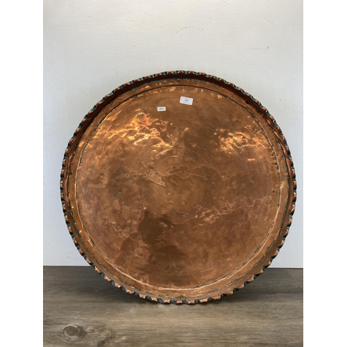 529 - A large early 20th century copper tray/charger - approx. 65cm diameter