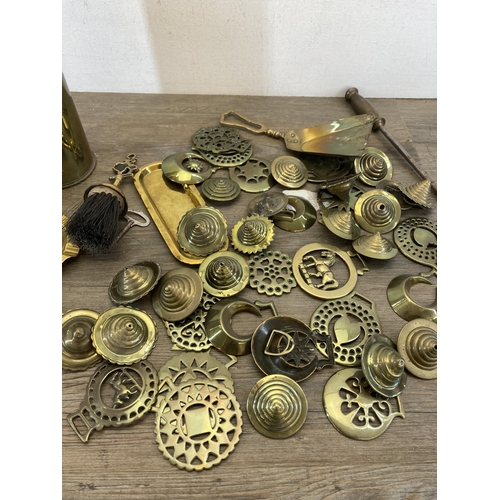 536 - A collection of 19th century and later brassware to include horse brasses, shell case, fire poker et... 