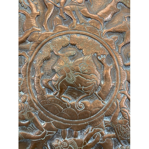 553 - An early 20th century Indian embossed copper wall charger approx. 47cm diameter