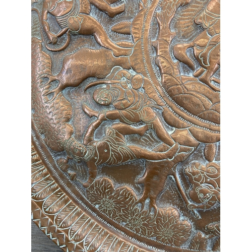 553 - An early 20th century Indian embossed copper wall charger approx. 47cm diameter