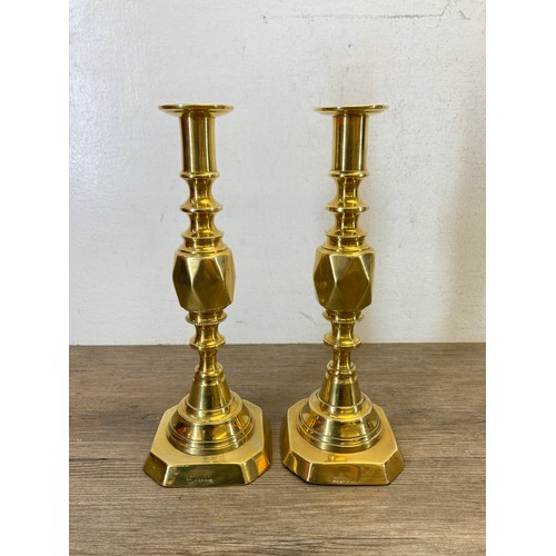 545 - Five pieces of brassware to include a pair of 19th century Diamond Princess candlesticks - approx. 2... 