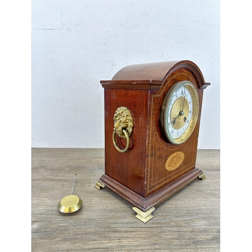 641 - An Edwardian mahogany mantel clock with domed case, oval shell inlay, boxwood and ebony stringing, b... 