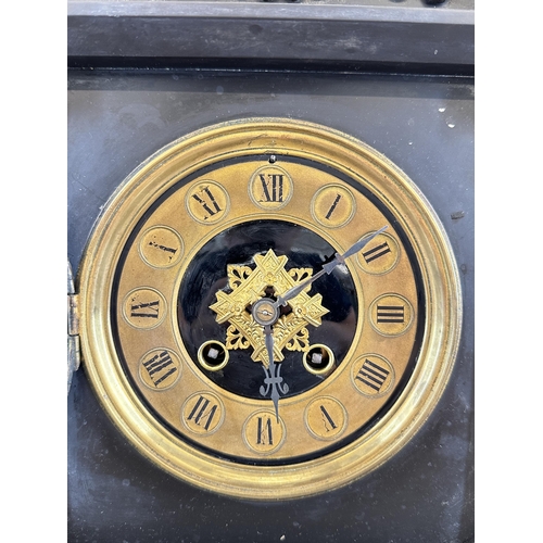 643 - A 19th century black slate and brass chiming mantel clock with Corinthian column sides and arched to... 