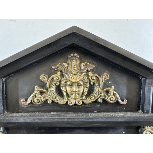 643 - A 19th century black slate and brass chiming mantel clock with Corinthian column sides and arched to... 