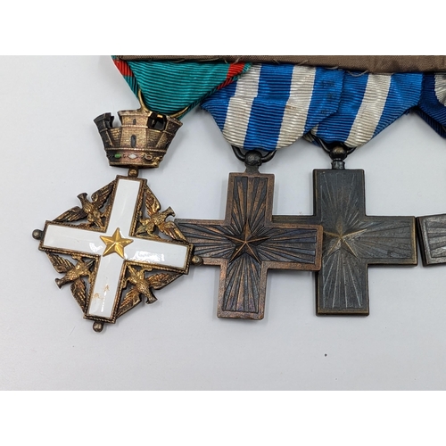 2154 - An Italian five piece medal group comprising four War Merit Cross and one Order of Merit Cross