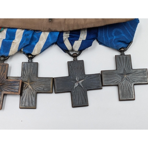 2154 - An Italian five piece medal group comprising four War Merit Cross and one Order of Merit Cross