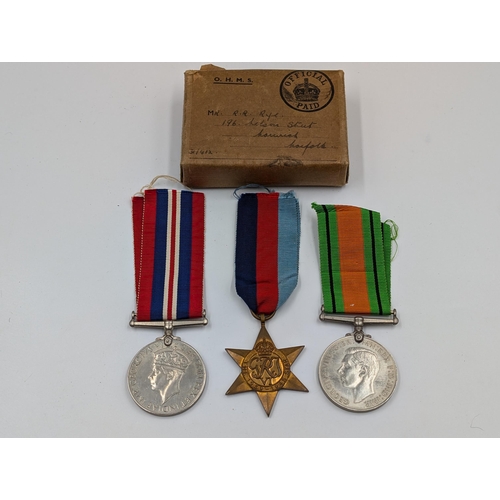 2168 - A WWII British medal trio with box presented to Mr. R.R. Rye