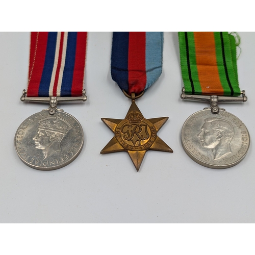 2168 - A WWII British medal trio with box presented to Mr. R.R. Rye