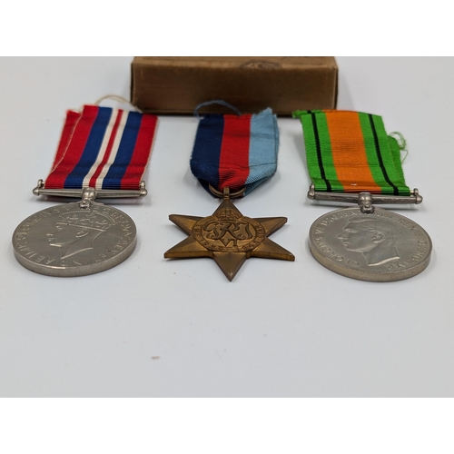 2168 - A WWII British medal trio with box presented to Mr. R.R. Rye