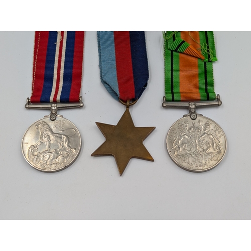 2168 - A WWII British medal trio with box presented to Mr. R.R. Rye