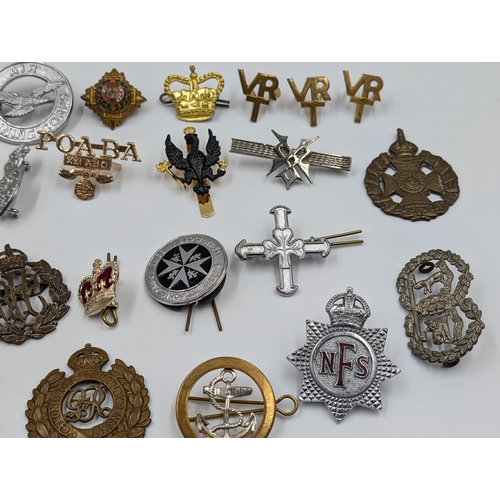 2172 - A collection of badges to include The St. John Ambulance Association, military etc.