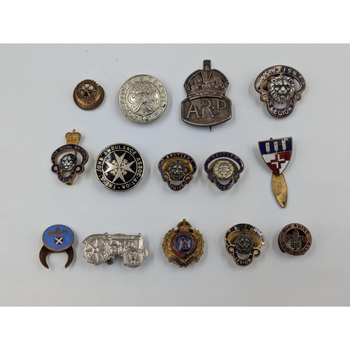 2174 - A collection of badges to include hallmarked sterling silver A.R.P., The Royal British Legion etc.