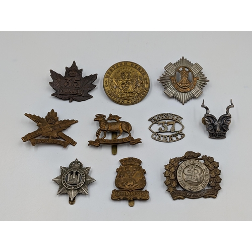 2188 - Ten military items, nine cap badges and one shoulder title