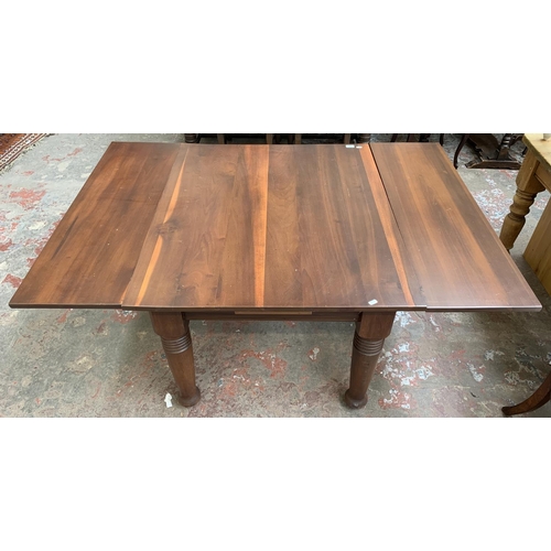 101 - A yew wood draw leaf extending dining table - approx. 73cm high x 106cm wide x 157cm long