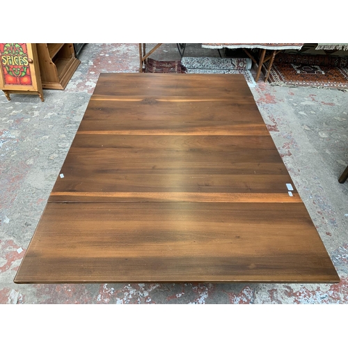 101 - A yew wood draw leaf extending dining table - approx. 73cm high x 106cm wide x 157cm long