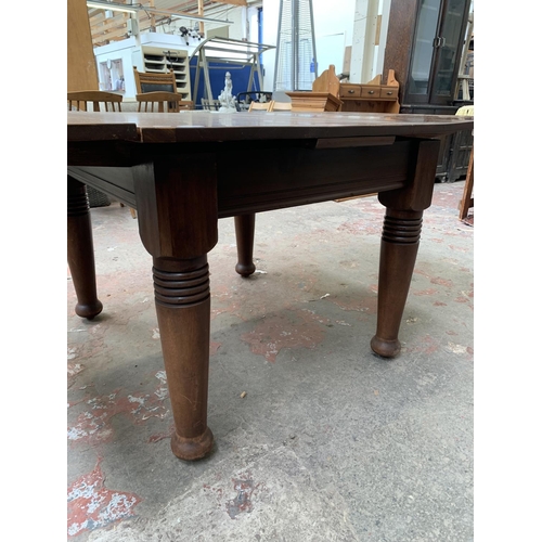 101 - A yew wood draw leaf extending dining table - approx. 73cm high x 106cm wide x 157cm long