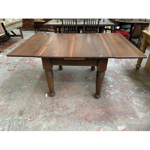 101 - A yew wood draw leaf extending dining table - approx. 73cm high x 106cm wide x 157cm long