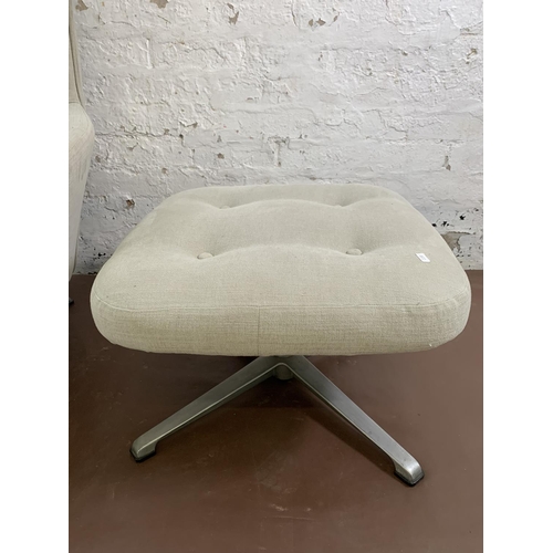 107 - A mid 20th century fabric upholstered swivel armchair and footstool on aluminium base - approx. 103c... 
