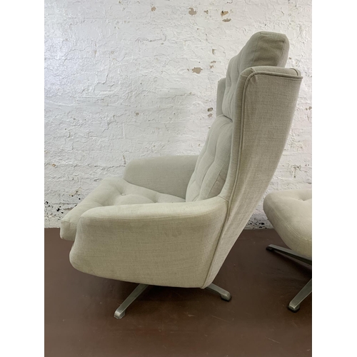 107 - A mid 20th century fabric upholstered swivel armchair and footstool on aluminium base - approx. 103c... 