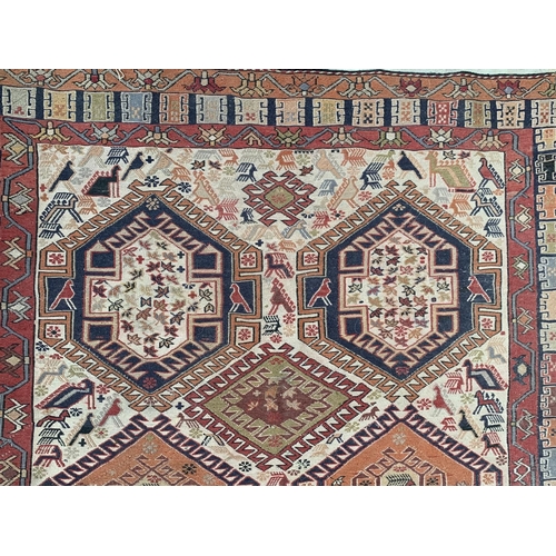 11 - An antique Persian hand knotted rug - approx. 200cm x 118cm