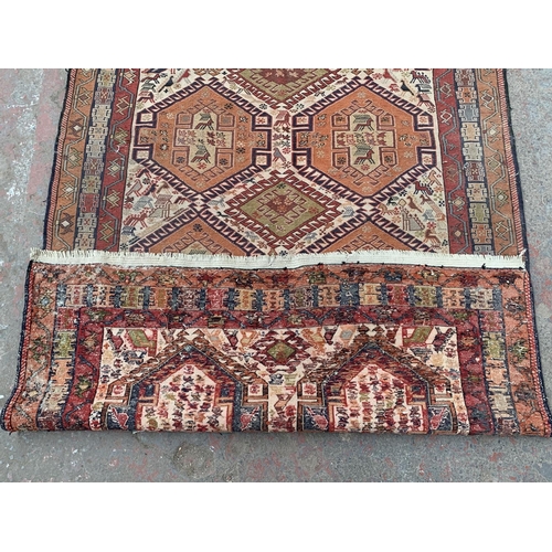 11 - An antique Persian hand knotted rug - approx. 200cm x 118cm