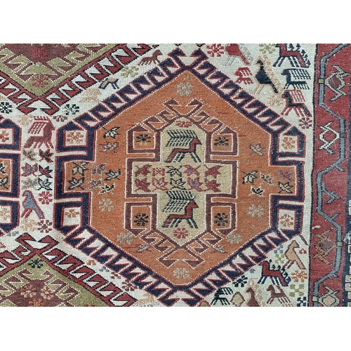 11 - An antique Persian hand knotted rug - approx. 200cm x 118cm