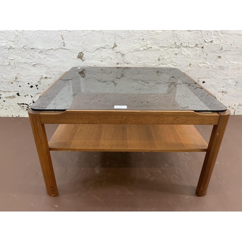 110 - A mid 20th century Myer teak and smoked glass coffee table - approx. 35cm high x 61cm wide x 61cm de... 