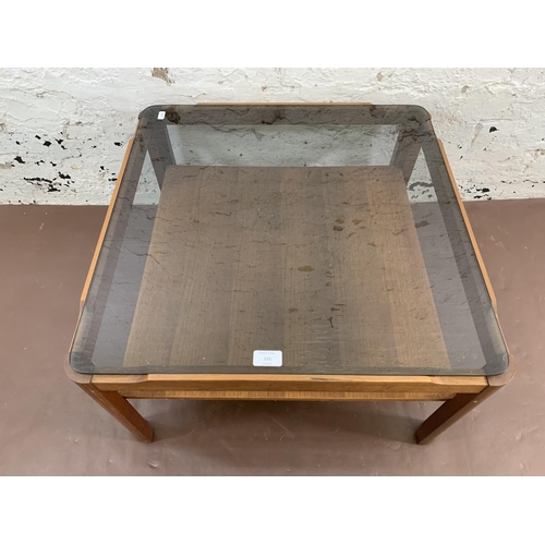 110 - A mid 20th century Myer teak and smoked glass coffee table - approx. 35cm high x 61cm wide x 61cm de... 